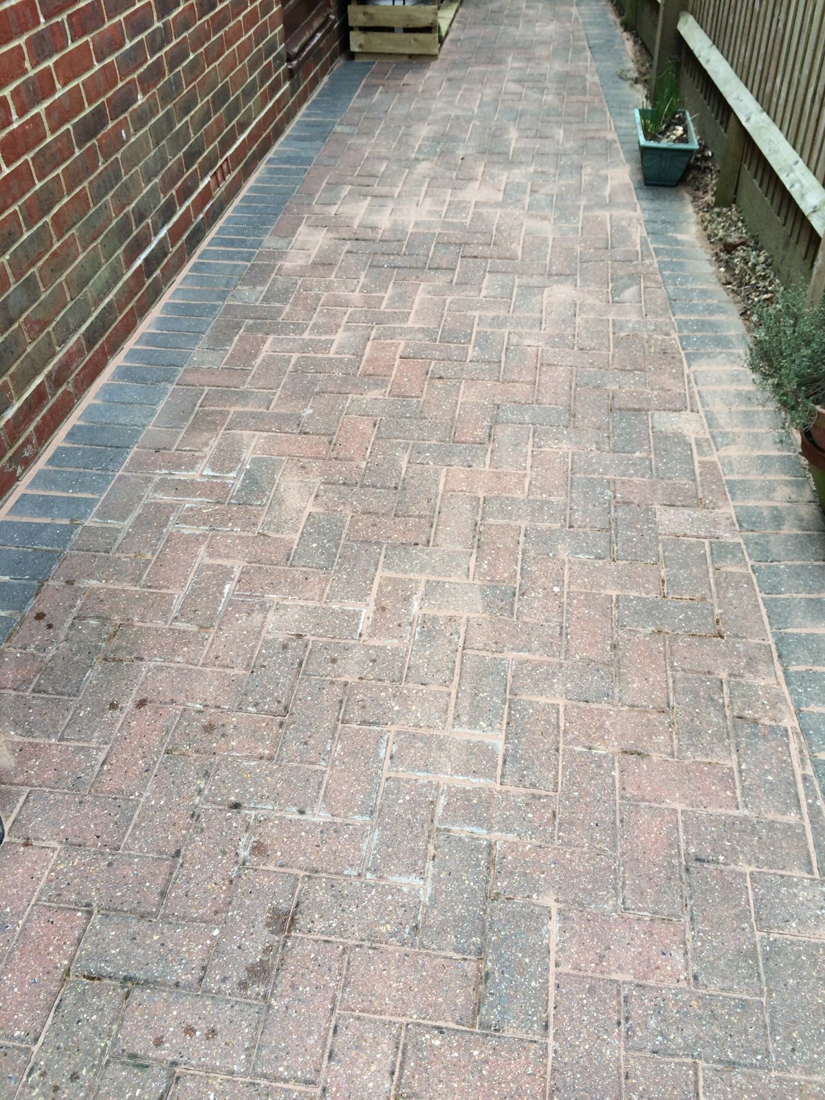 After: clean block paving with the original colour restored.