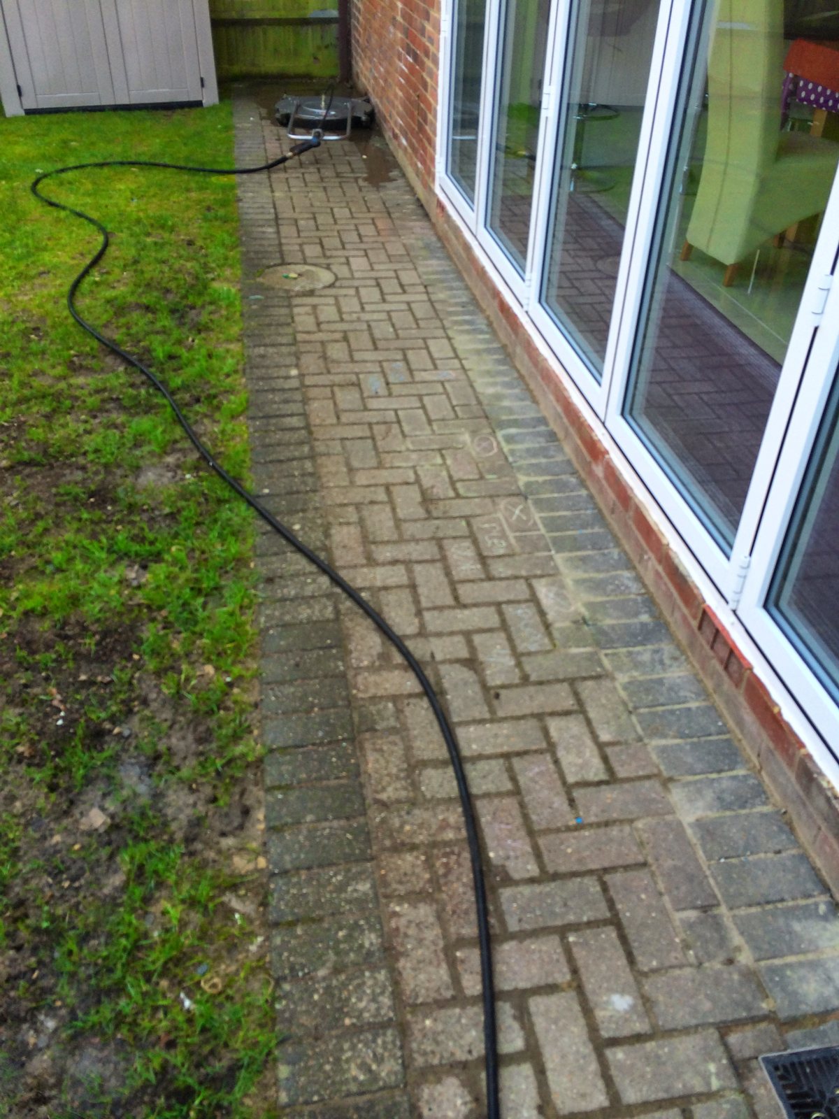 Before: faded, algae-stained block paving.
