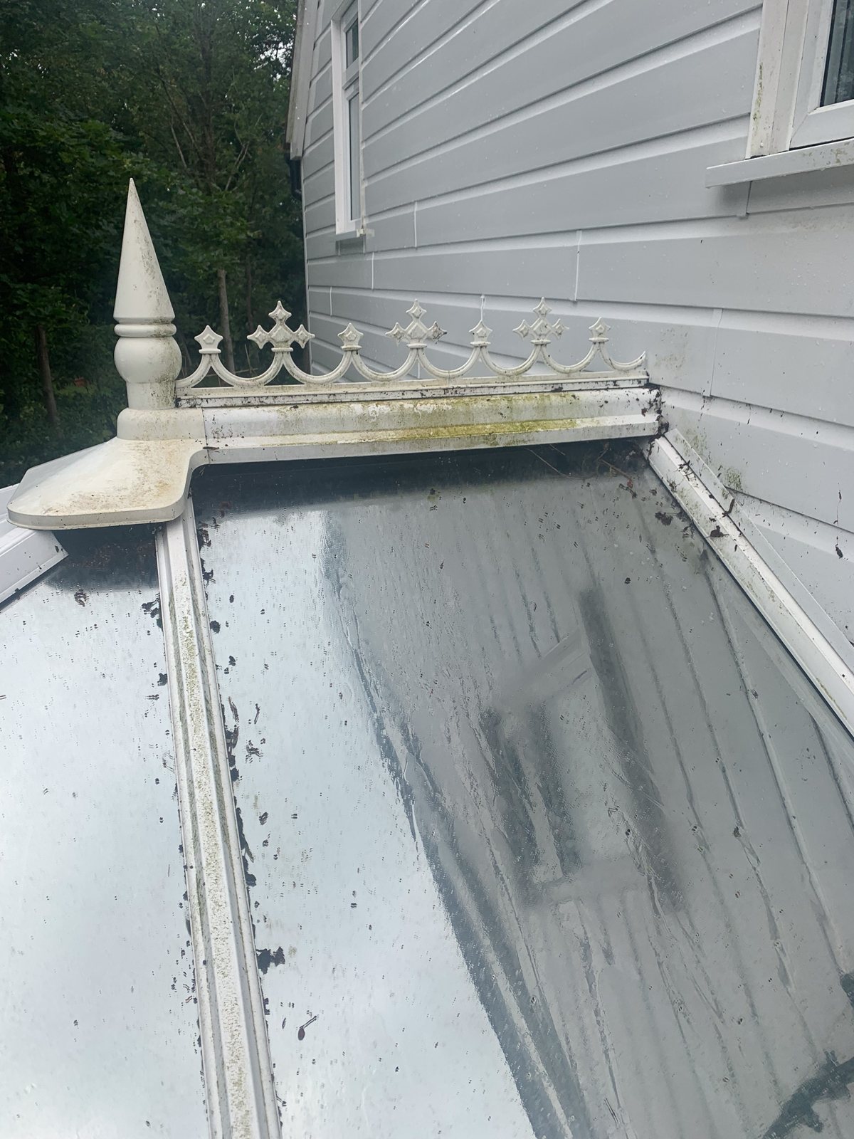 Conservatory roof with algae and dark streaks before cleaning in Dorking Surrey