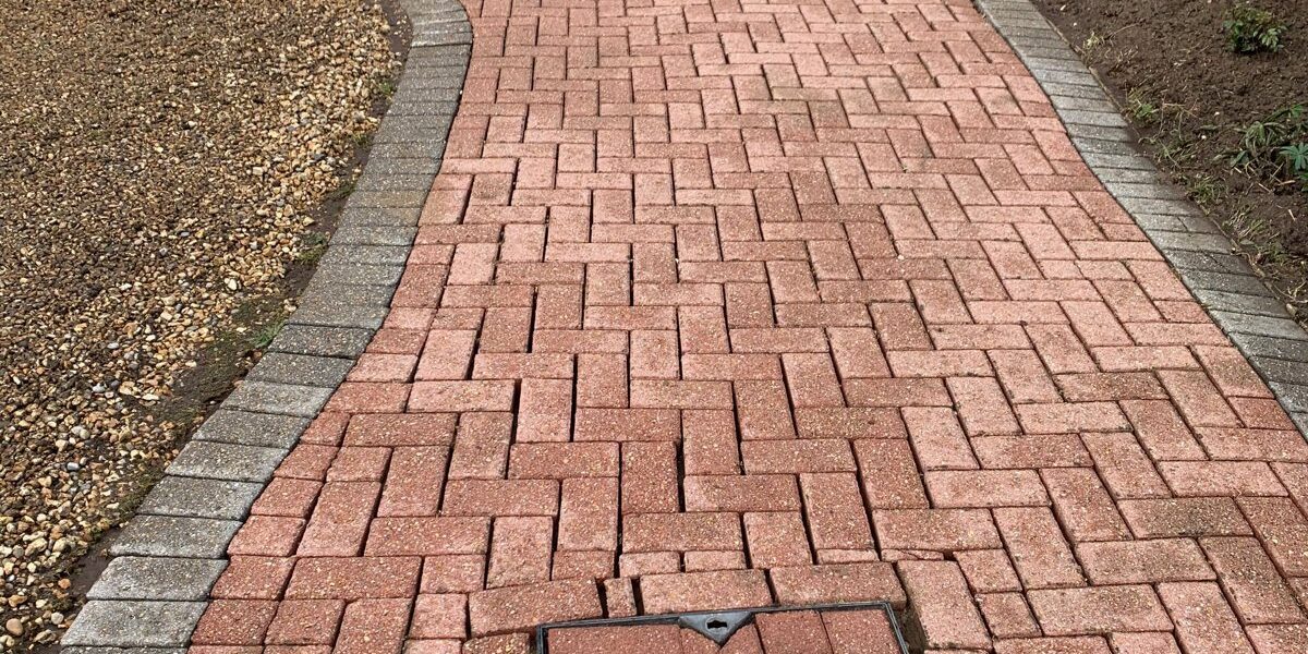 Freshly cleaned brick driveway path in Woking, Surrey