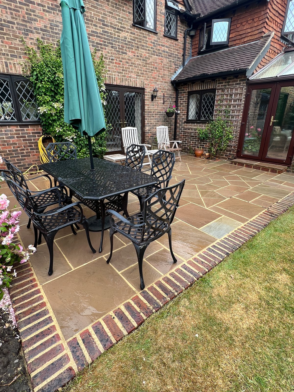 Sandstone patio in Horsham after black spot removal — natural colour restored