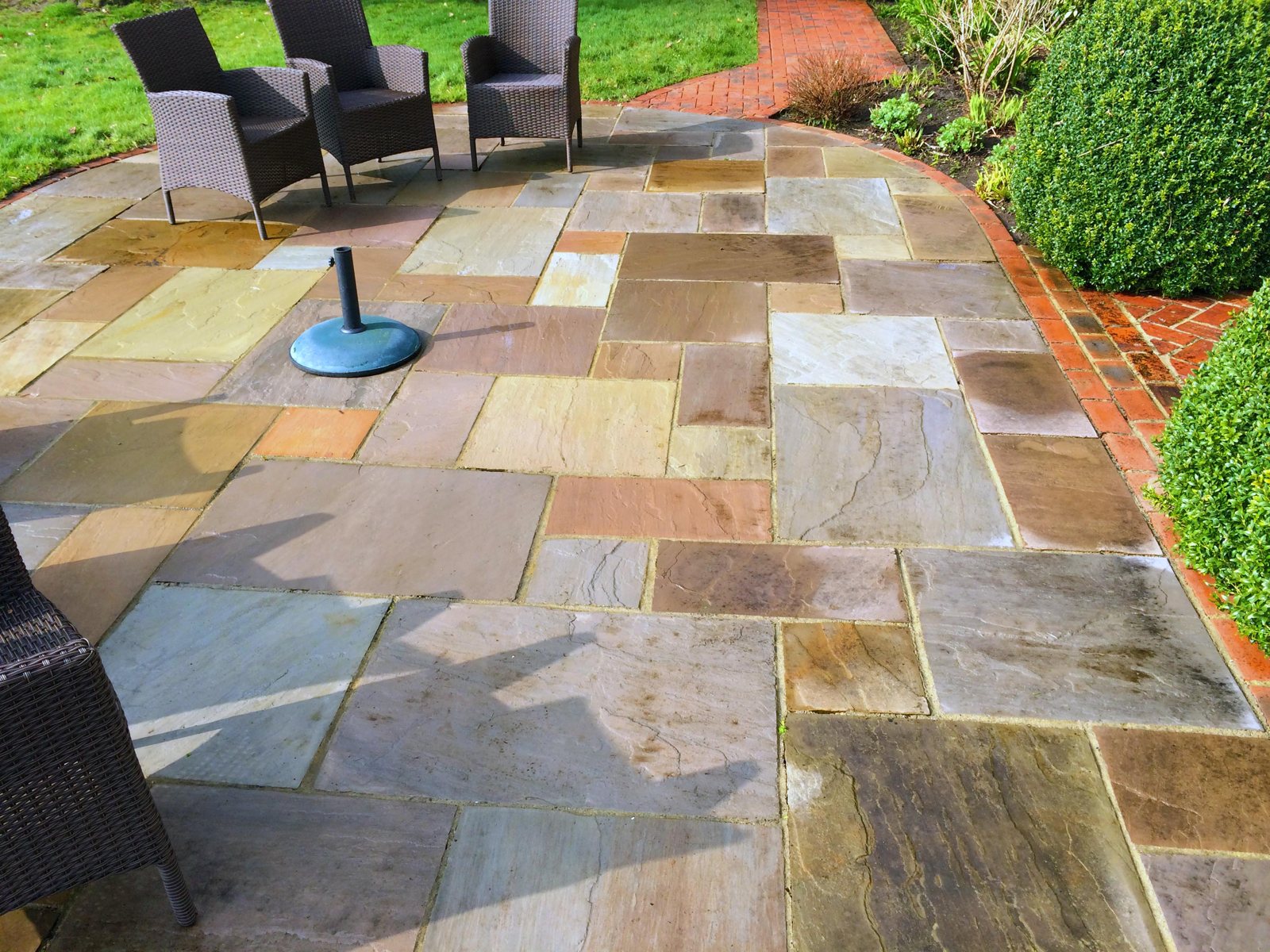 After: clean paths and patio with the colour restored.