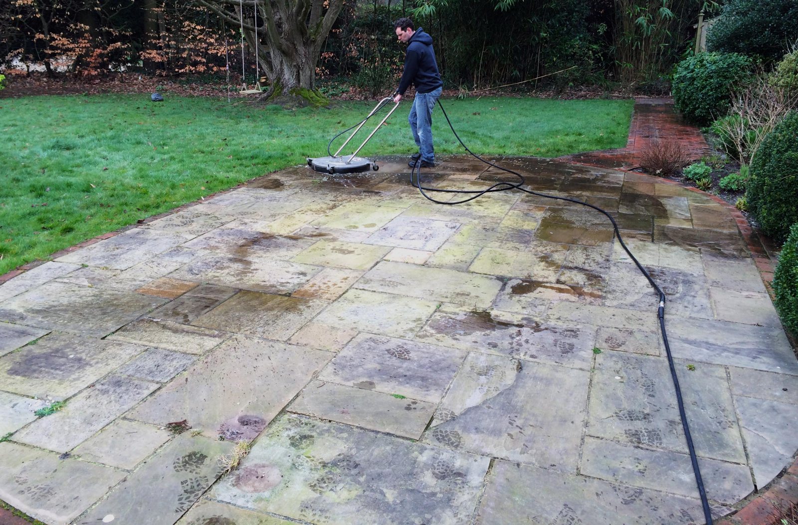 Before: paths and paving darkened with algae and ingrained dirt.