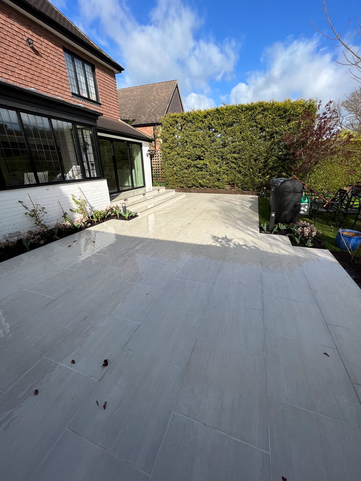 Porcelain patio in Horsley Surrey after cleaning — bright white and clean