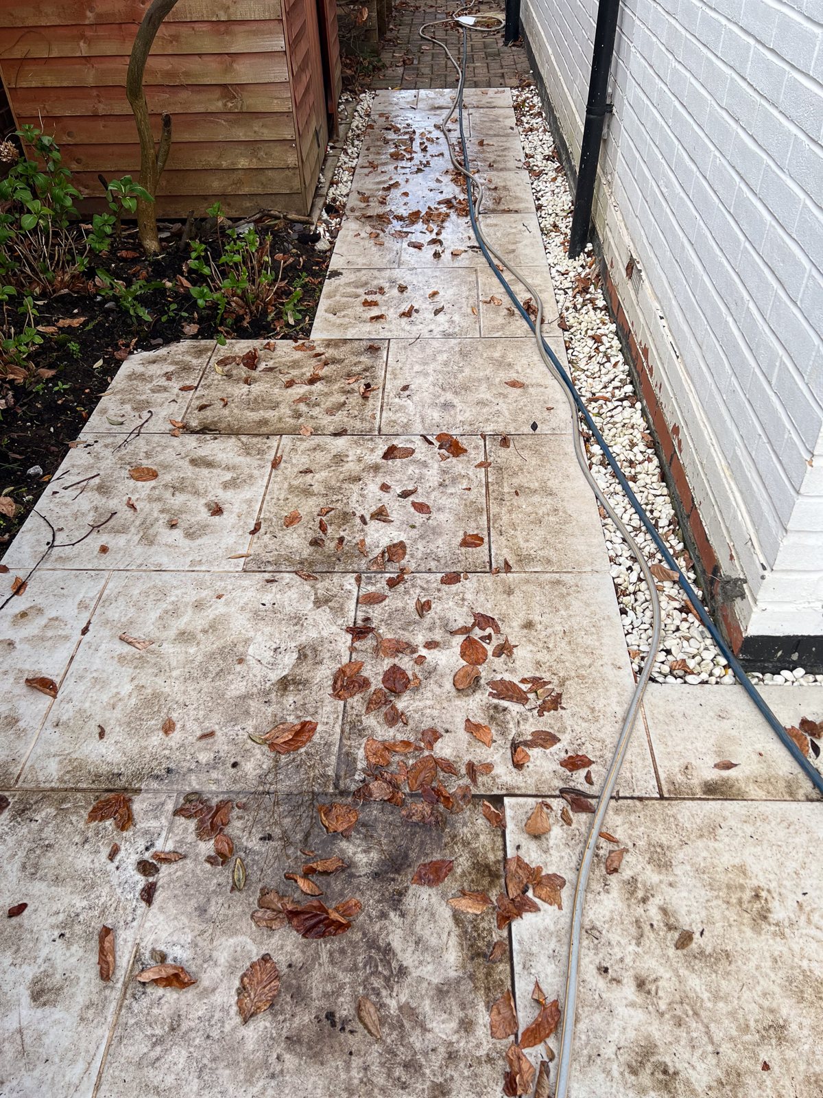 Porcelain patio in Horsley Surrey before cleaning — stained and discoloured