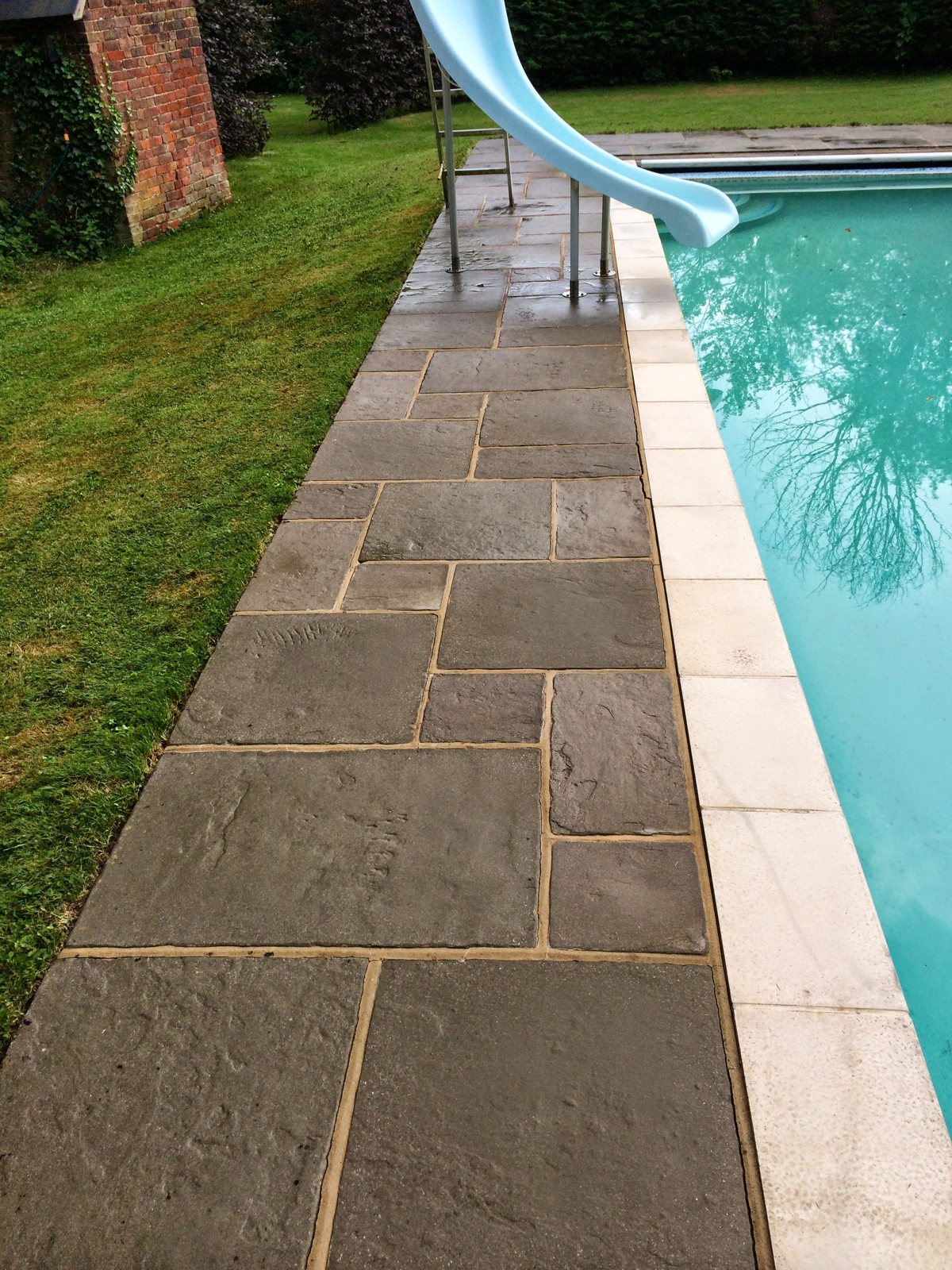 After: clean, safe paving and paths around the pool.