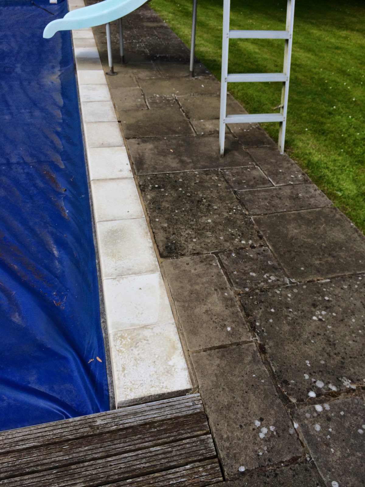 Before: dirty, algae-stained paving around the pool.