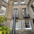 Water-fed pole cleaning fourth-floor sash windows from the ground, Gomshall near Guildford