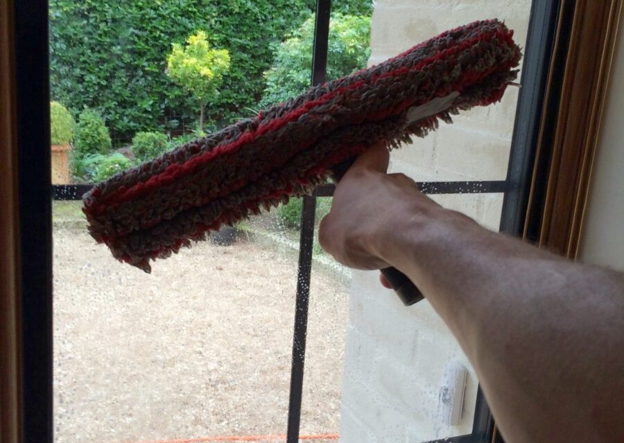 Cleaning the glass and frame of a window in Surrey