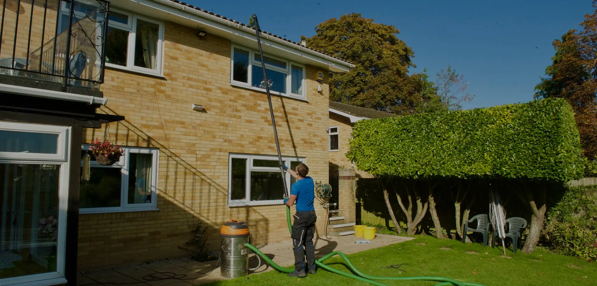 Clearing gutters with a gutter vacuum from the ground in Guildford
