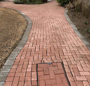 Freshly cleaned brick driveway path in Woking, Surrey
